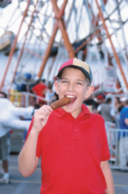 child eating corndog